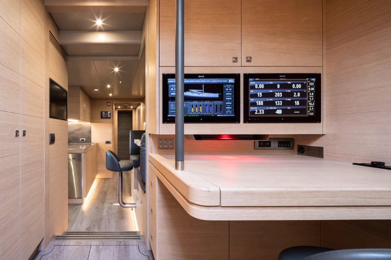 a room with a counter and chairs aboard ALICE Yacht for Sale