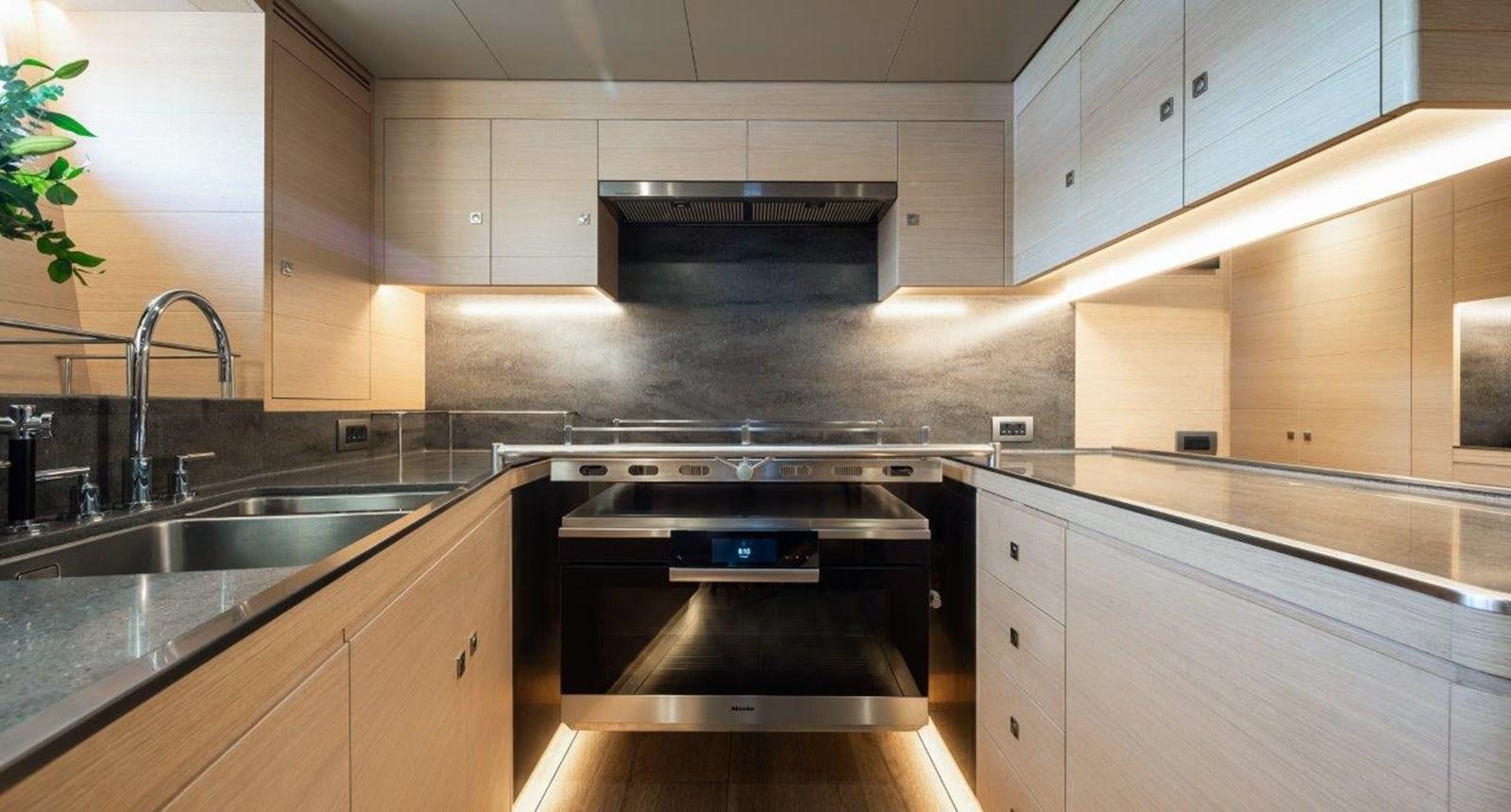 a kitchen with a stove and sink aboard ALICE Yacht for Sale