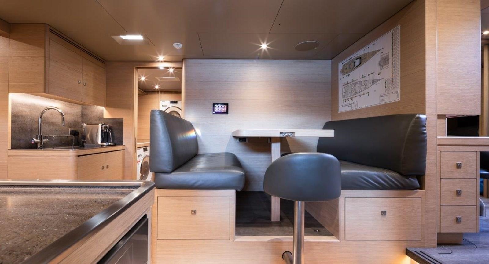 a kitchen with a couch and a chair aboard ALICE Yacht for Sale