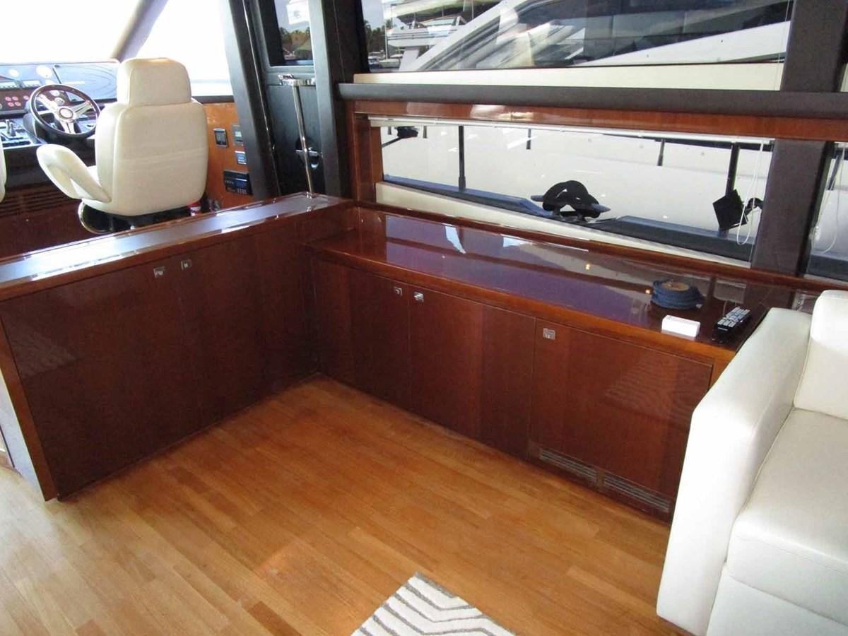 a room with a white chair and a wood floor aboard MOJO II Yacht for Sale