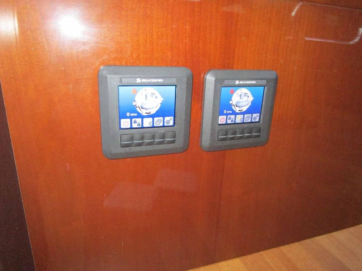 a group of rectangular electronic devices on a wooden surface aboard MOJO II Yacht for Sale