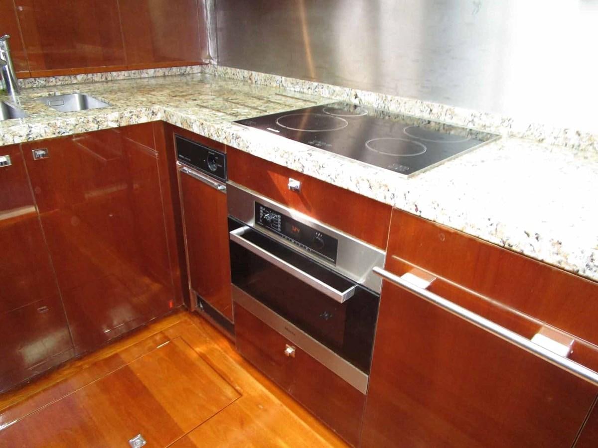 a kitchen with a stove and cabinets aboard MOJO II Yacht for Sale