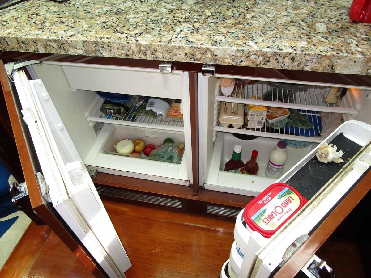 a refrigerator with its doors open aboard MOJO II Yacht for Sale