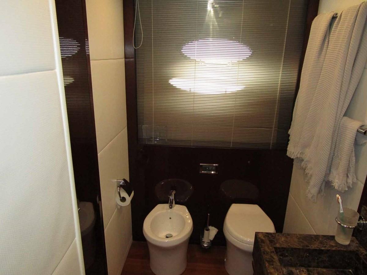 a bathroom with a toilet and sink aboard MOJO II Yacht for Sale