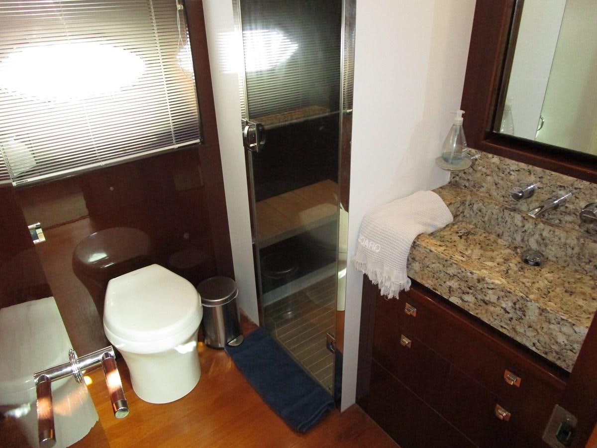 a bathroom with a glass shower aboard MOJO II Yacht for Sale