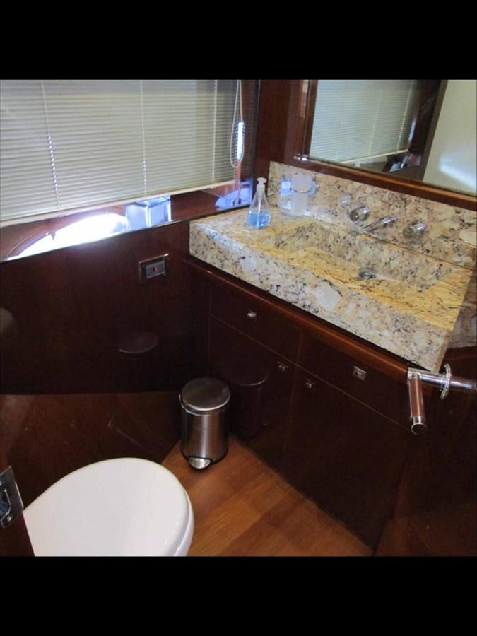 a bathroom with a countertop sink and a window aboard MOJO II Yacht for Sale