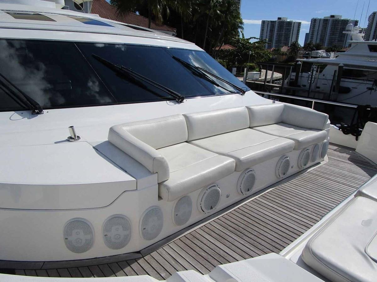 a white car with a large white convertible top aboard MOJO II Yacht for Sale