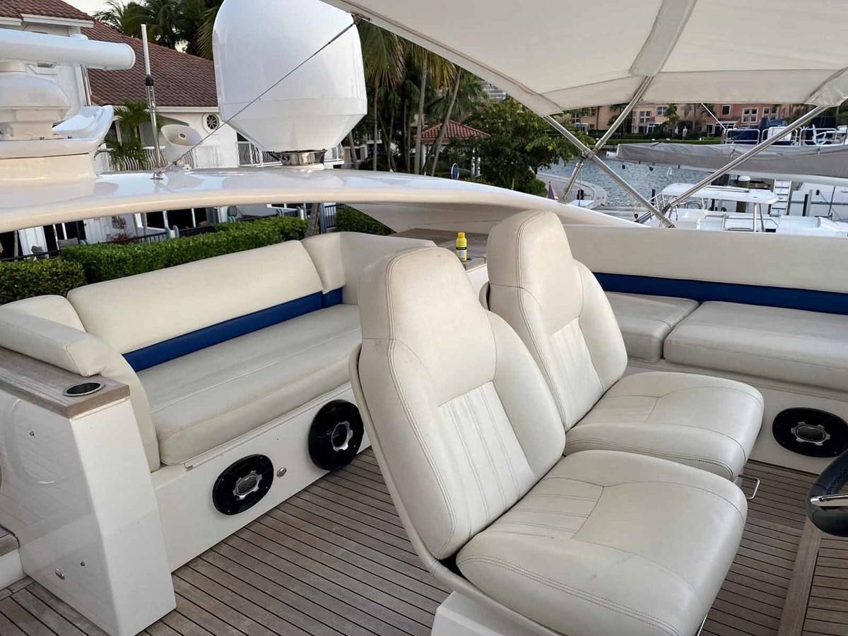 a white car with a black steering wheel on a deck aboard MOJO II Yacht for Sale