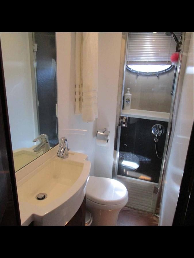 a bathroom with a glass shower door aboard MOJO II Yacht for Sale