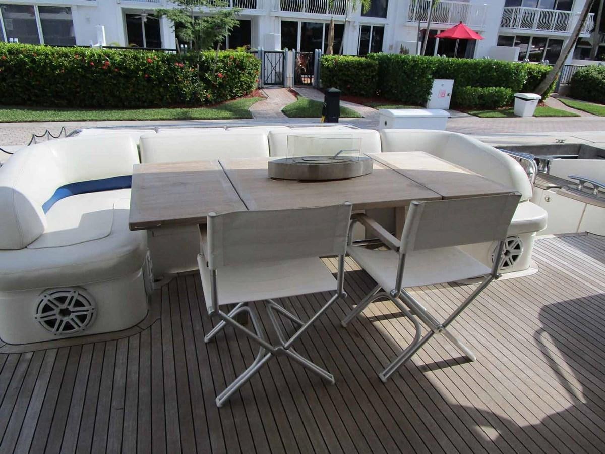 a table and chairs outside aboard MOJO II Yacht for Sale