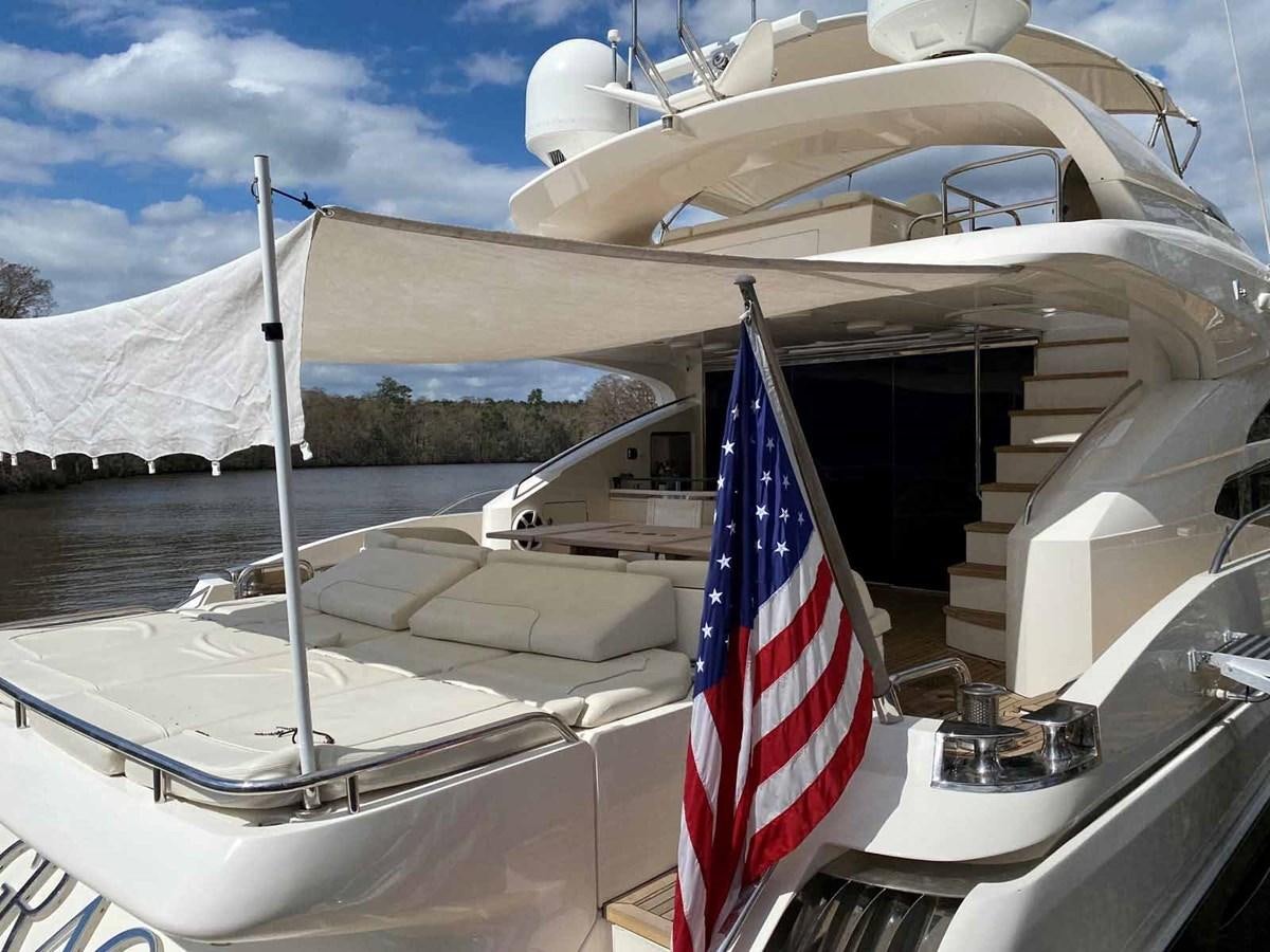 a boat with a flag on the front aboard MOJO II Yacht for Sale
