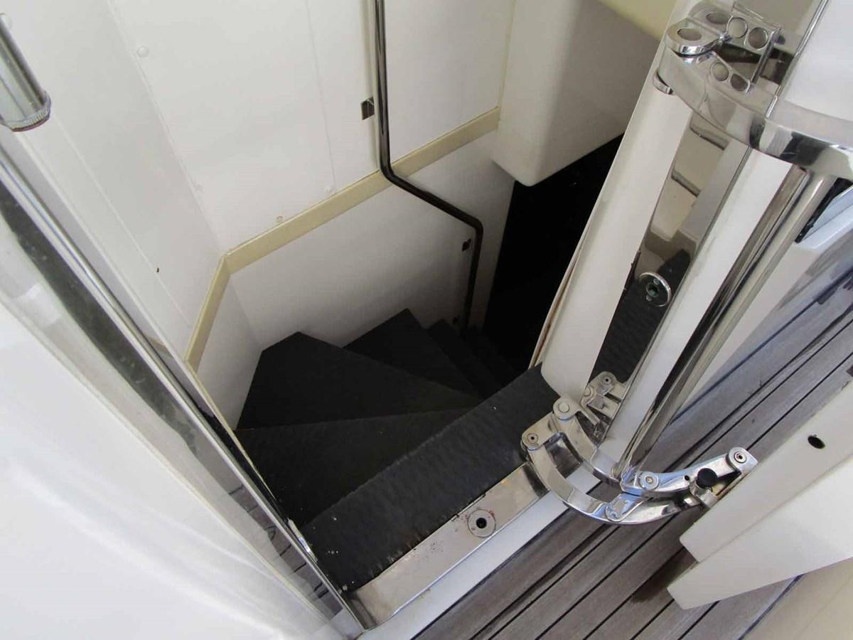 a white staircase with a glass railing aboard MOJO II Yacht for Sale