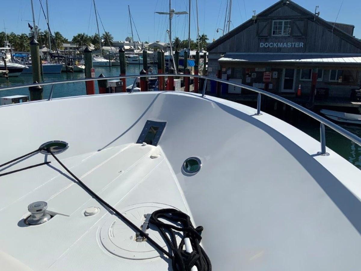 a white boat on a dock aboard LADY GRACE Yacht for Sale