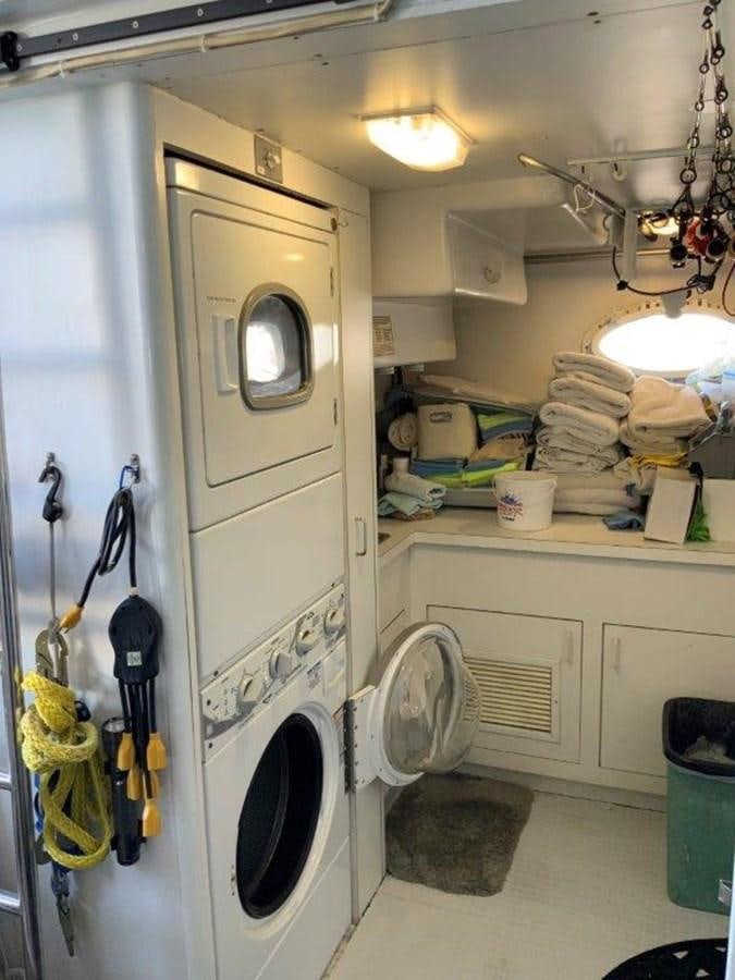 a laundry room with clothes on the dryer aboard LADY GRACE Yacht for Sale