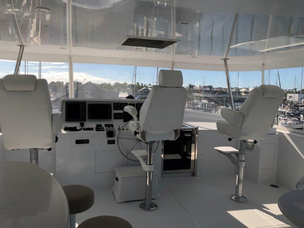 a room with several white chairs and a table with white chairs aboard LADY GRACE Yacht for Sale