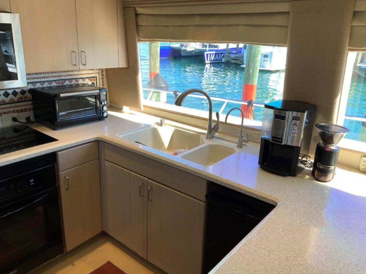 a kitchen with a sink and microwave aboard LADY GRACE Yacht for Sale