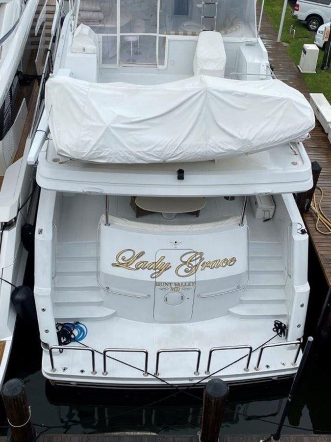 a white bed with a white sheet aboard LADY GRACE Yacht for Sale