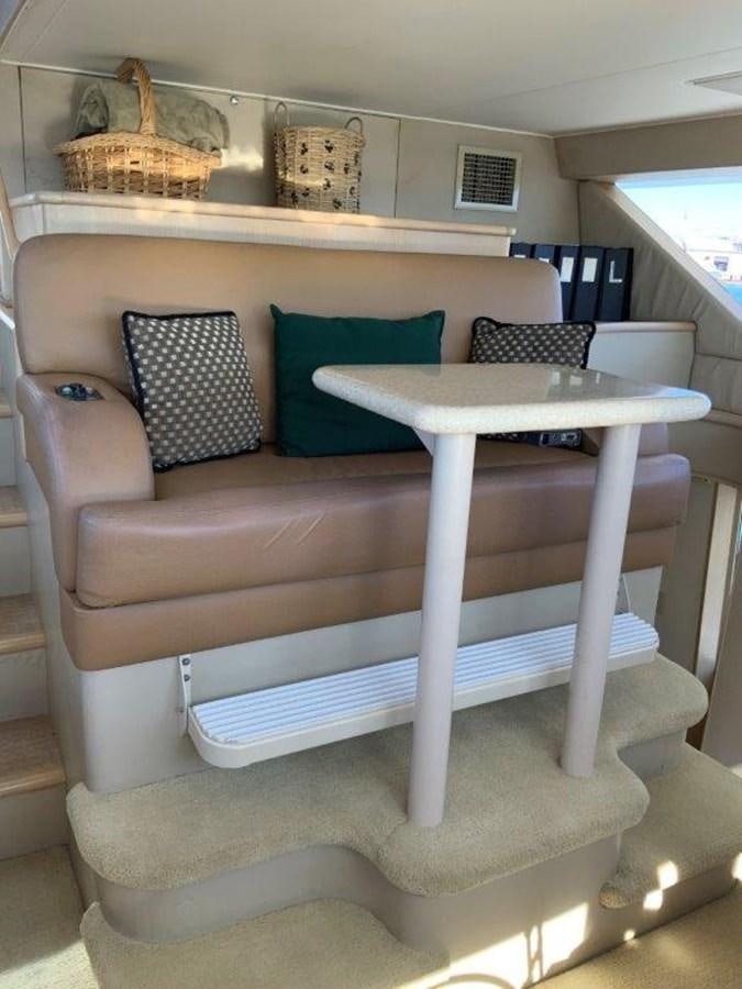 a couch with a table and a basket on top aboard LADY GRACE Yacht for Sale