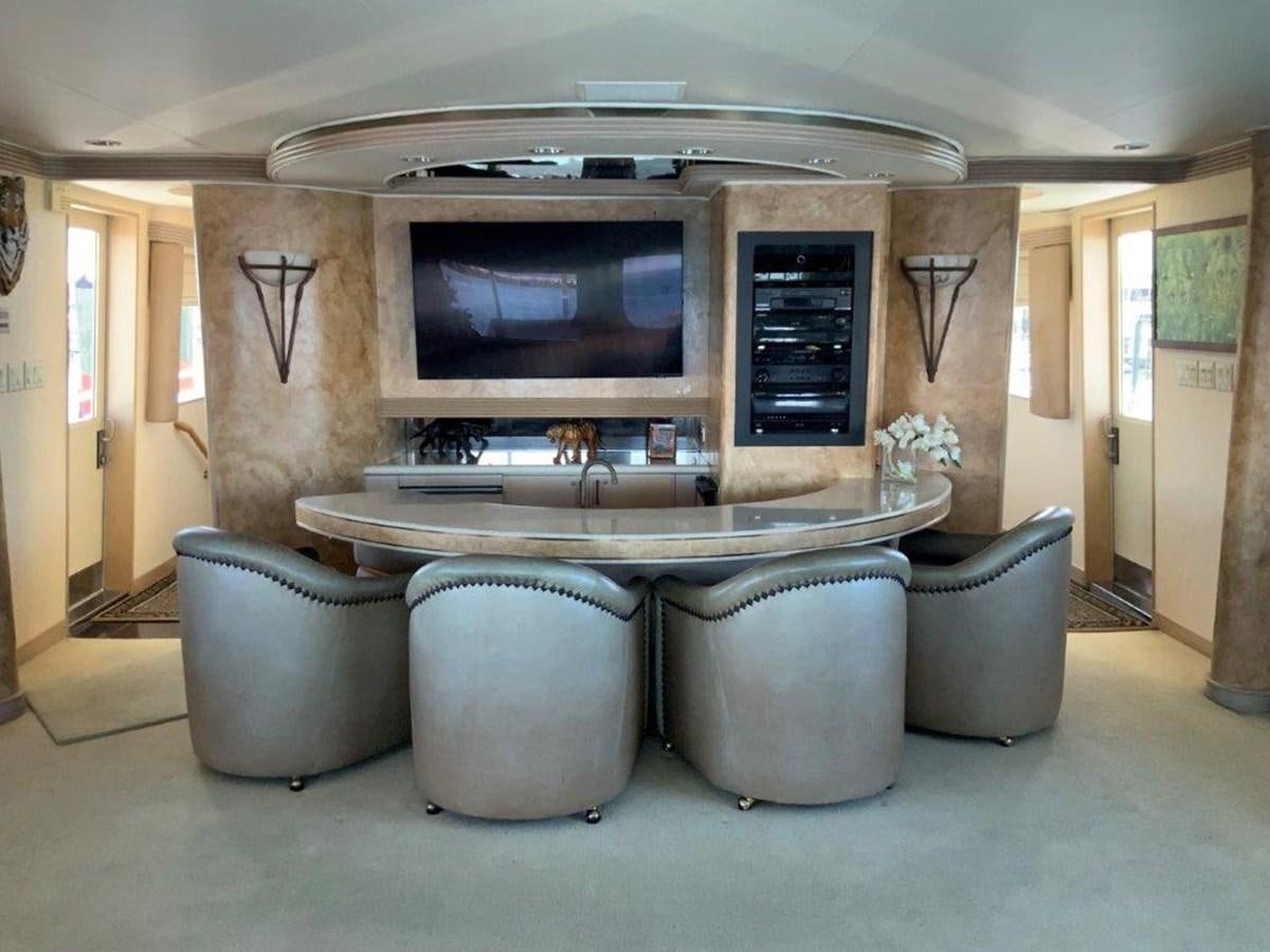 a large flat screen television on a stand in a room aboard LADY GRACE Yacht for Sale