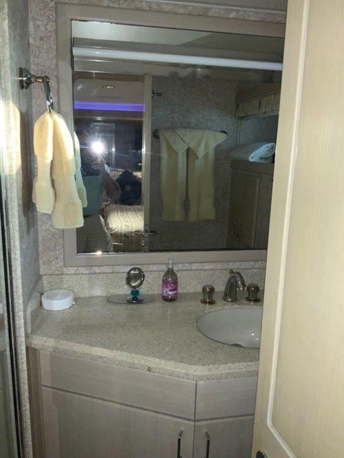 a bathroom with a sink and a mirror aboard LADY GRACE Yacht for Sale