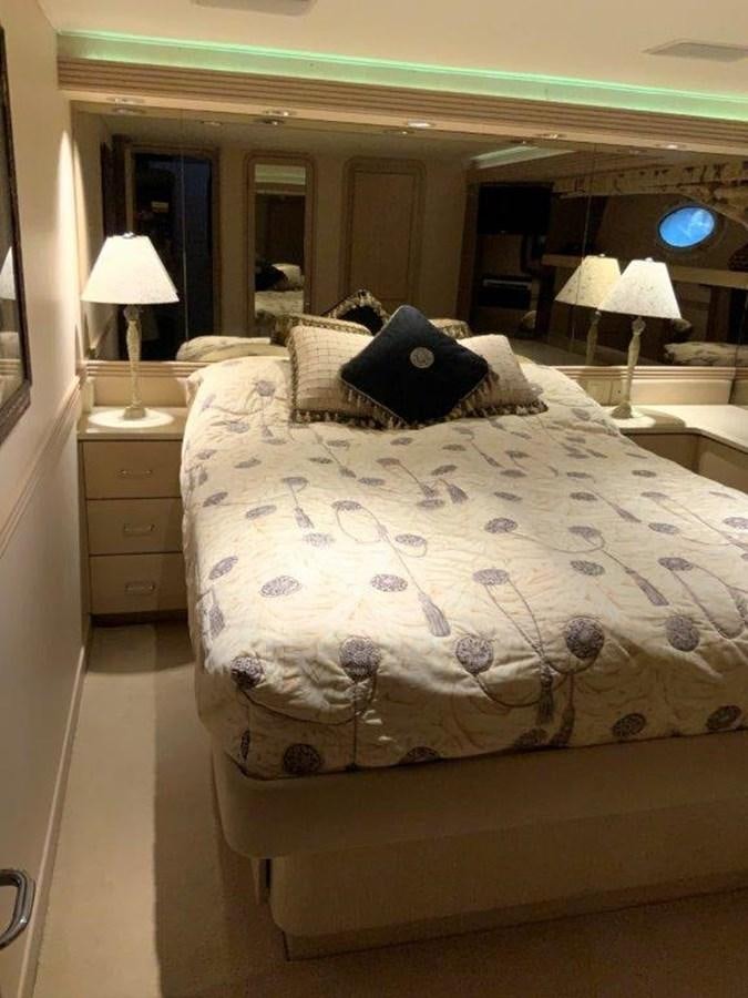 a bed with a blue pillow aboard LADY GRACE Yacht for Sale