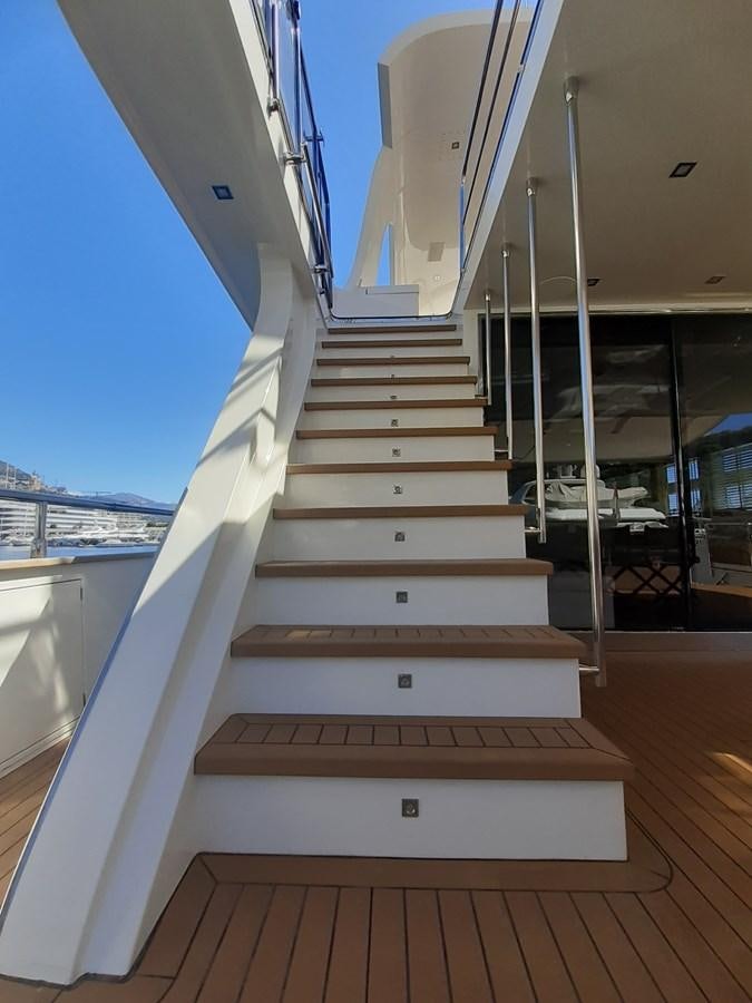 a white staircase with a railing aboard MR. GU Yacht for Sale