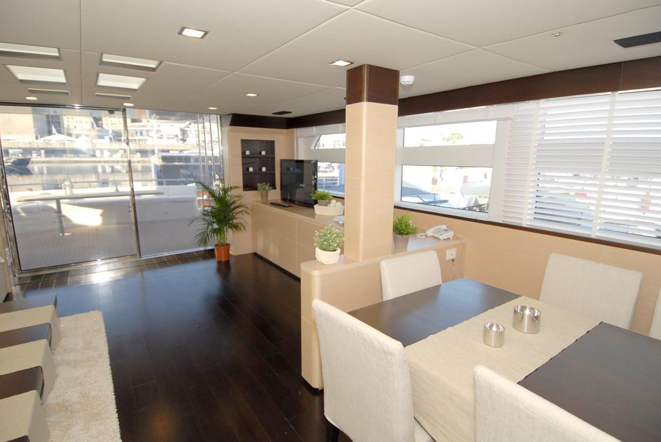 a large room with tables and chairs aboard MR. GU Yacht for Sale