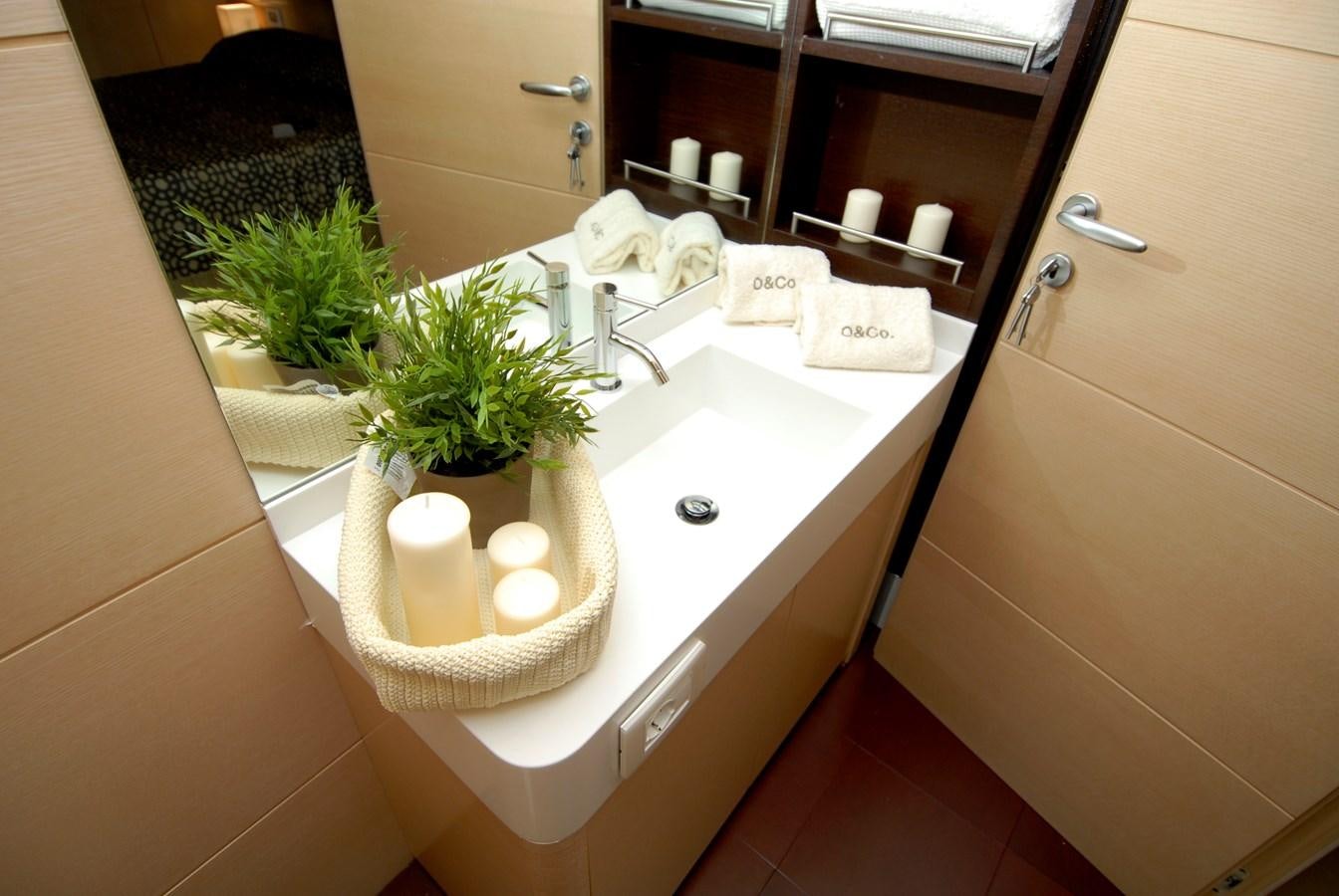 a bathroom with a sink and candles aboard MR. GU Yacht for Sale