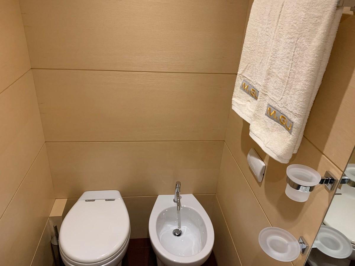 a bathroom with a toilet and a sink aboard MR. GU Yacht for Sale
