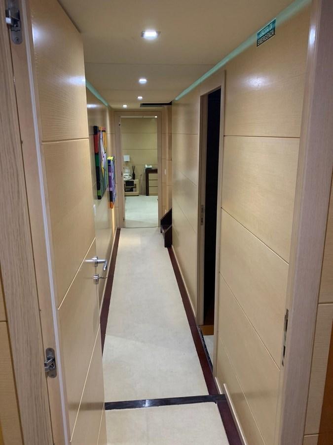 a hallway with a glass door aboard MR. GU Yacht for Sale