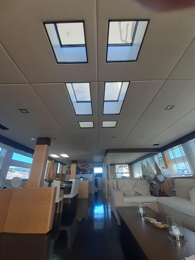 a room with a table and chairs aboard MR. GU Yacht for Sale