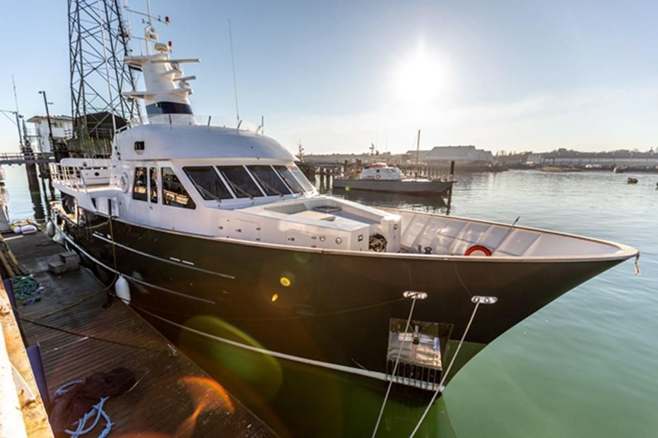 a large white boat docked aboard HISTORY Yacht for Sale