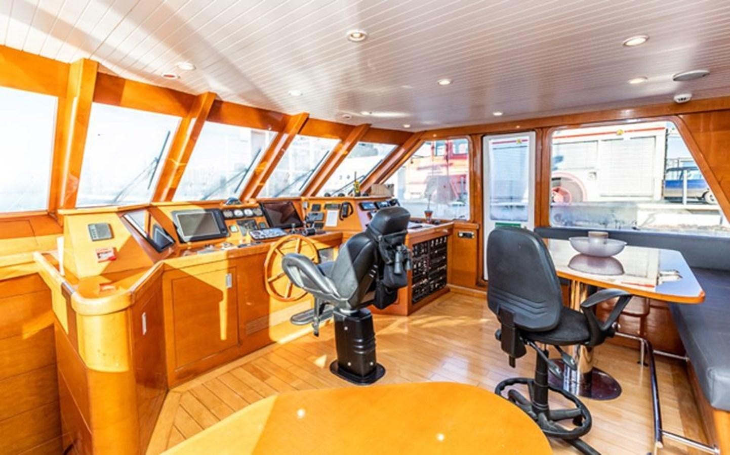 a room with a table and chairs aboard HISTORY Yacht for Sale