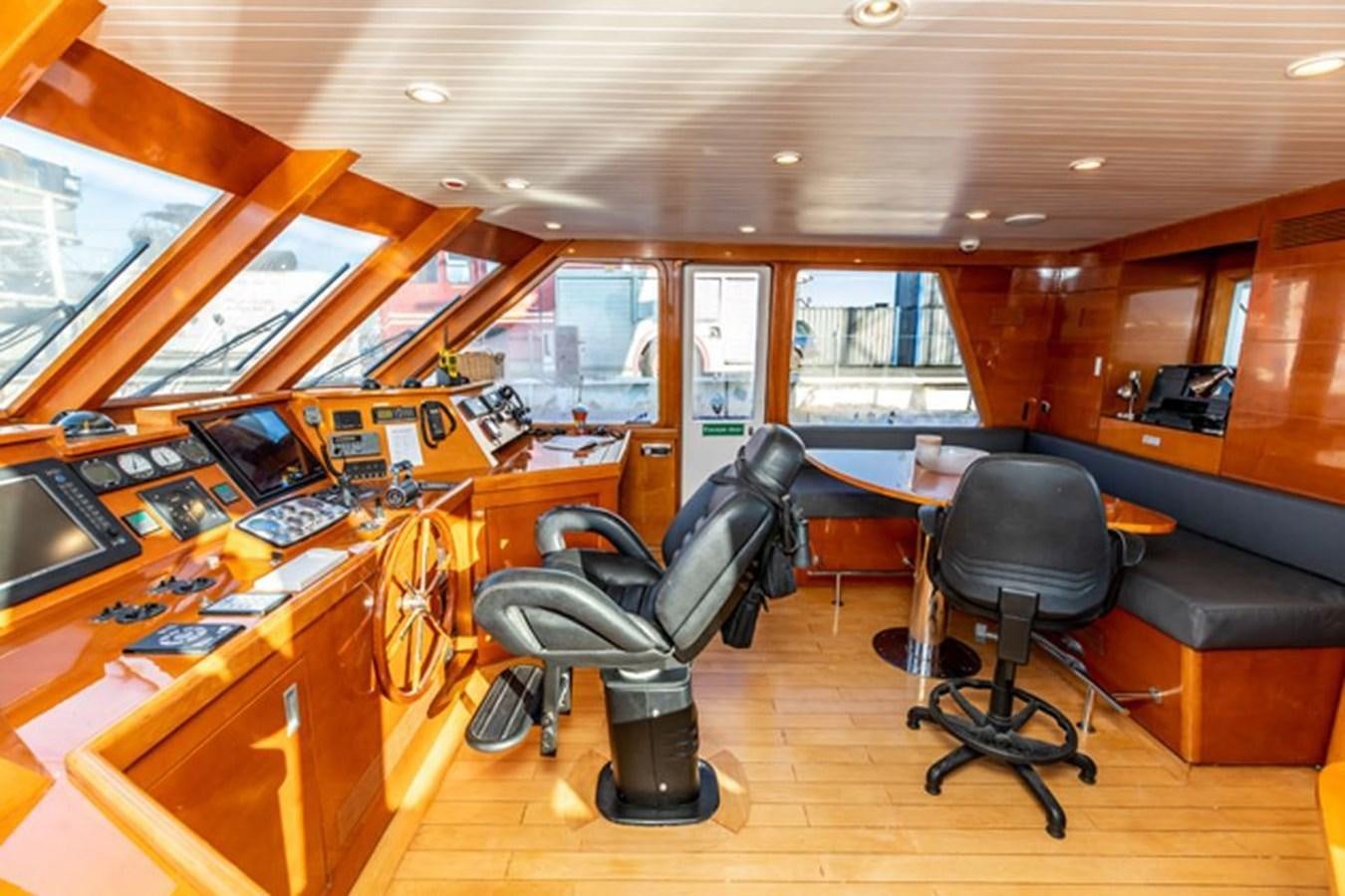 a room with a desk and chairs aboard HISTORY Yacht for Sale