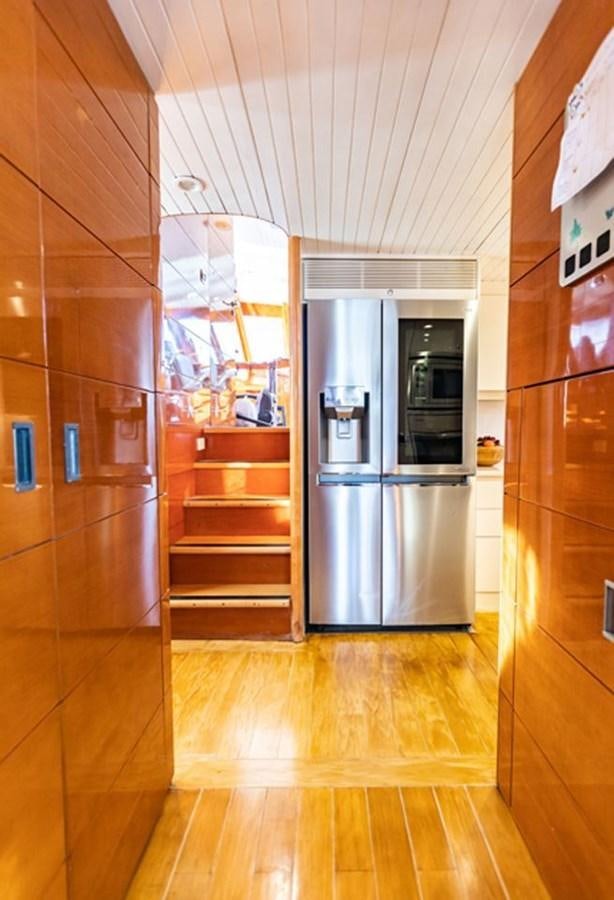 a kitchen with a stainless steel refrigerator aboard HISTORY Yacht for Sale