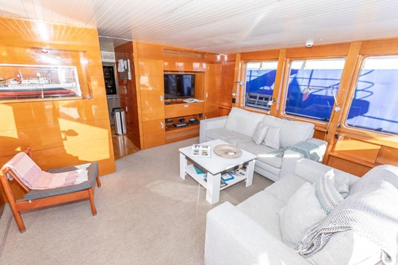 a living room with a large window aboard HISTORY Yacht for Sale
