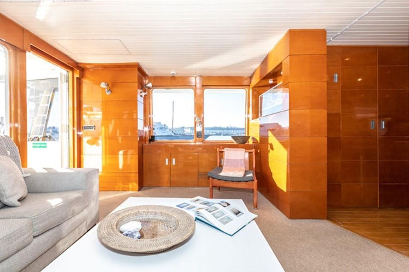 a living room with a couch and a table aboard HISTORY Yacht for Sale