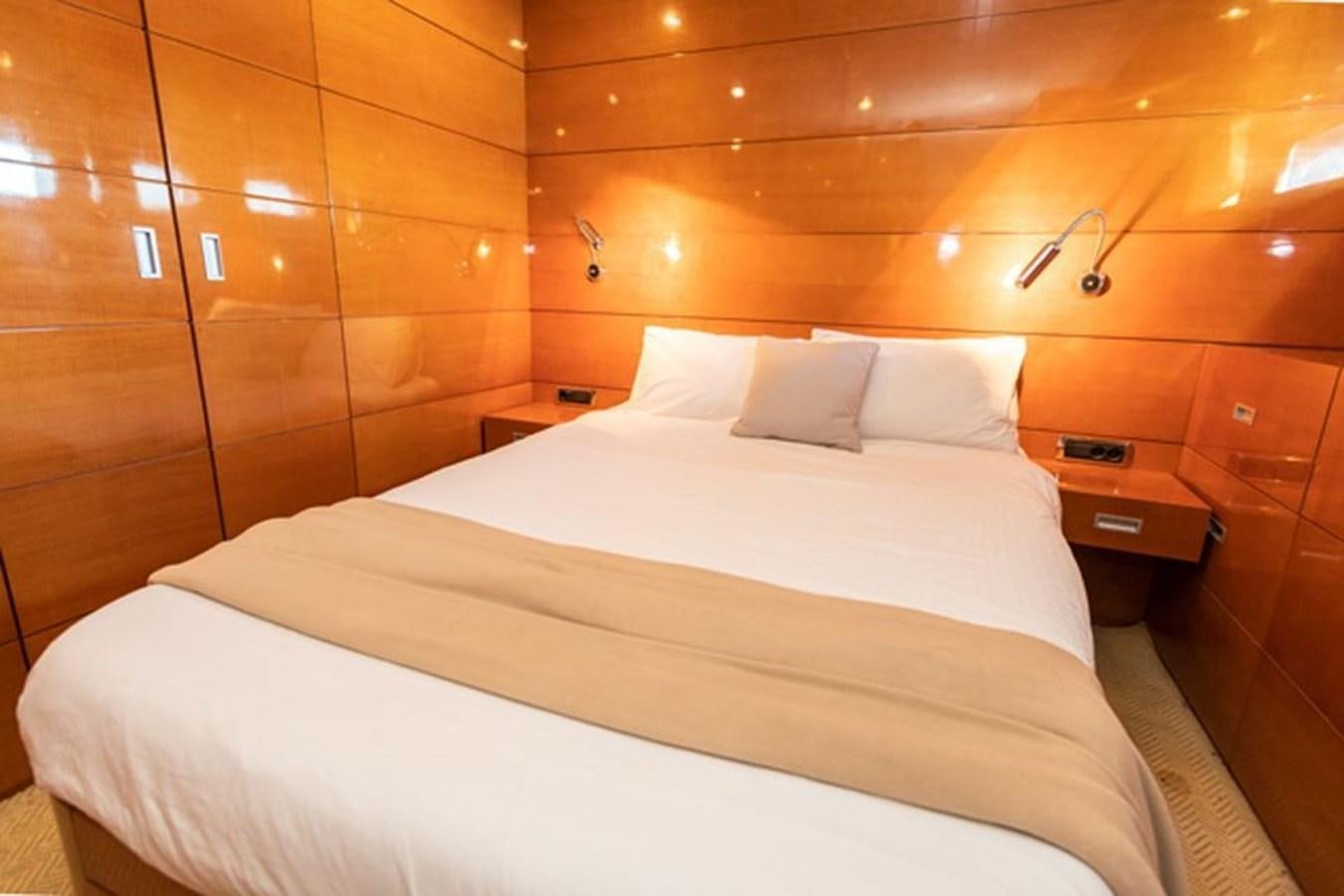 a bed with white sheets aboard HISTORY Yacht for Sale
