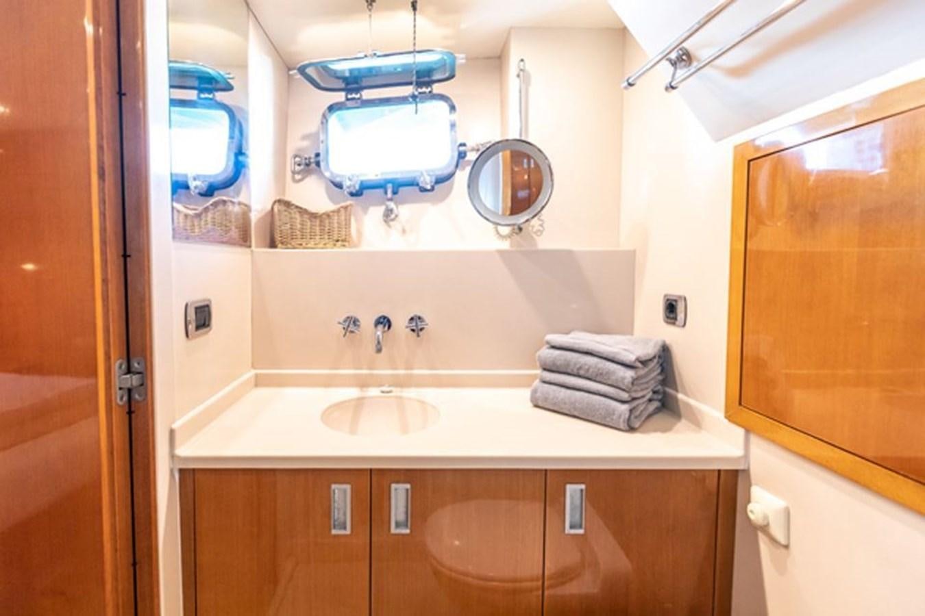 a bathroom with a sink and a mirror aboard HISTORY Yacht for Sale