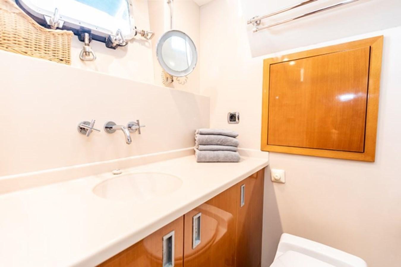 a bathroom with a sink and a mirror aboard HISTORY Yacht for Sale