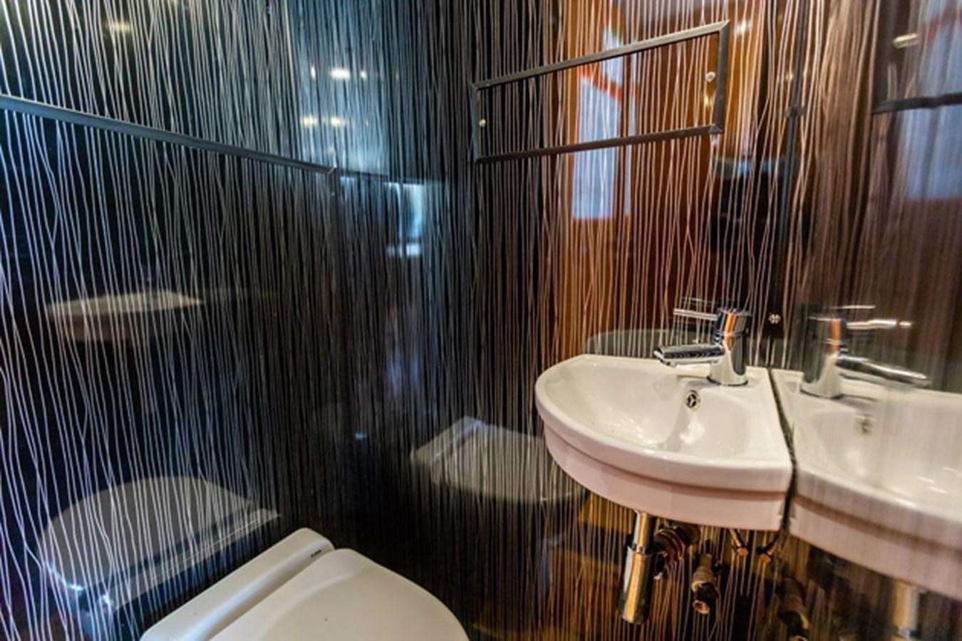 a bathroom with a sink and a shower aboard HISTORY Yacht for Sale