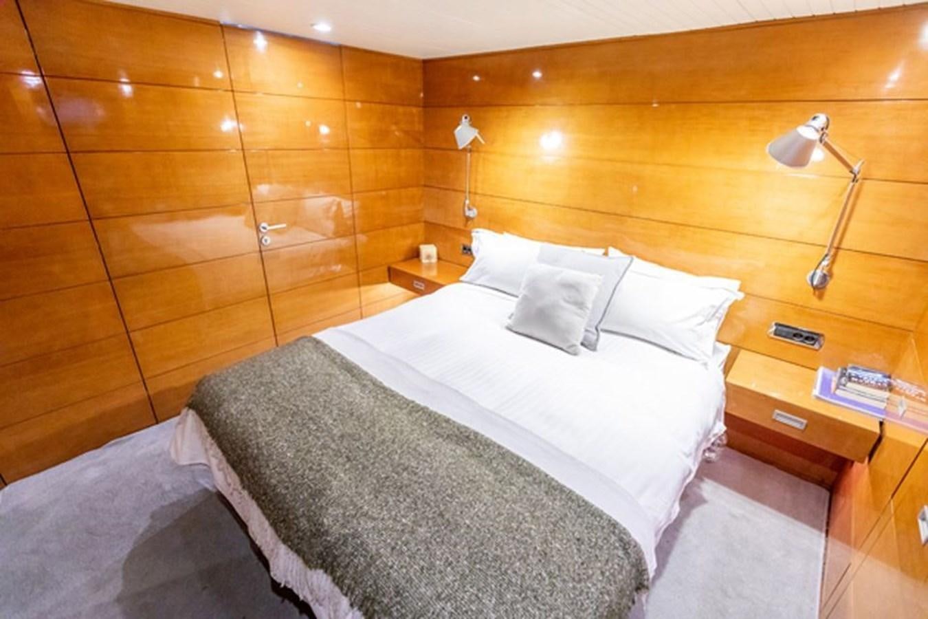 a bed with white sheets aboard HISTORY Yacht for Sale