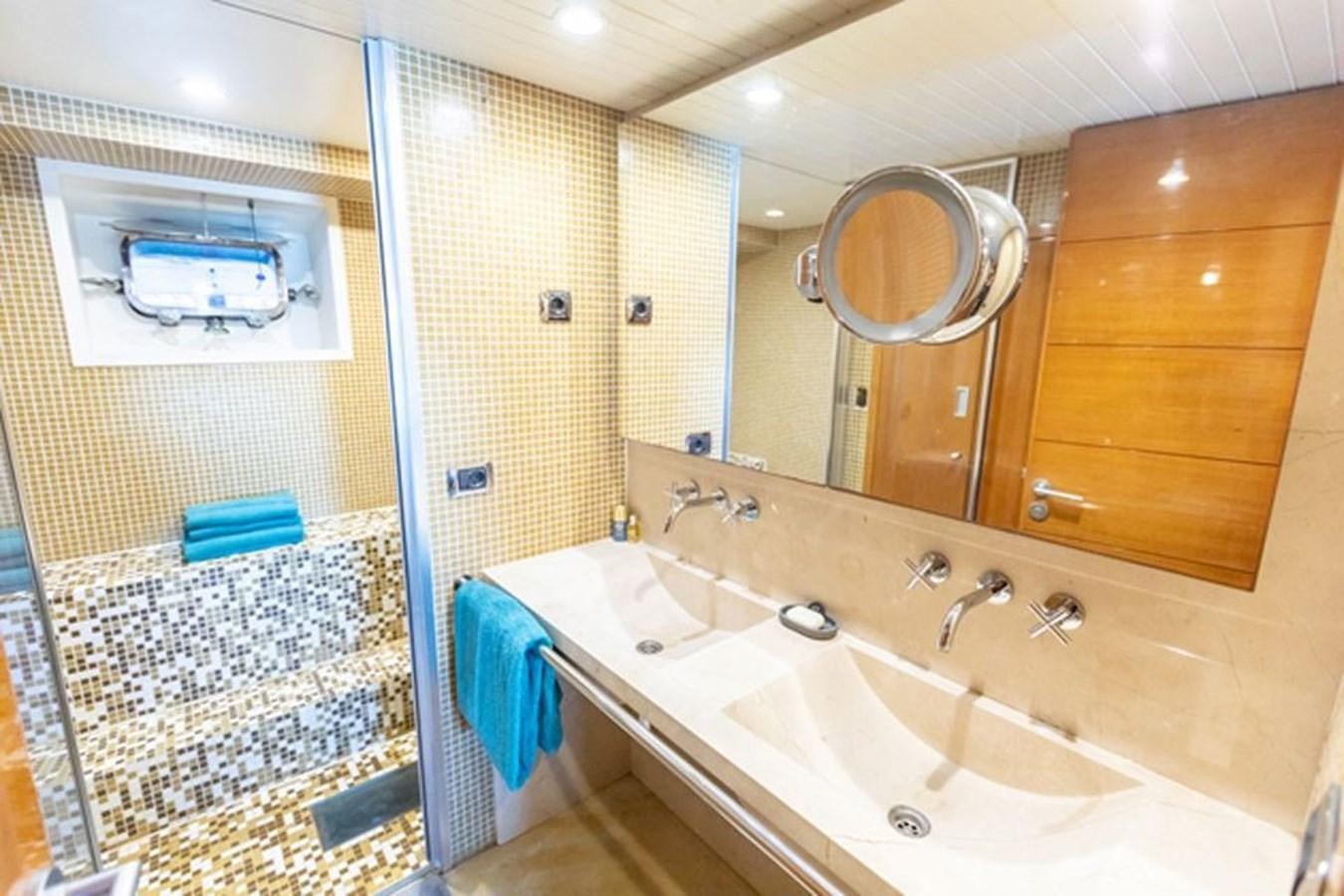 a bathroom with a large mirror aboard HISTORY Yacht for Sale