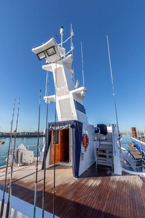 a large white boat on a dock aboard HISTORY Yacht for Sale