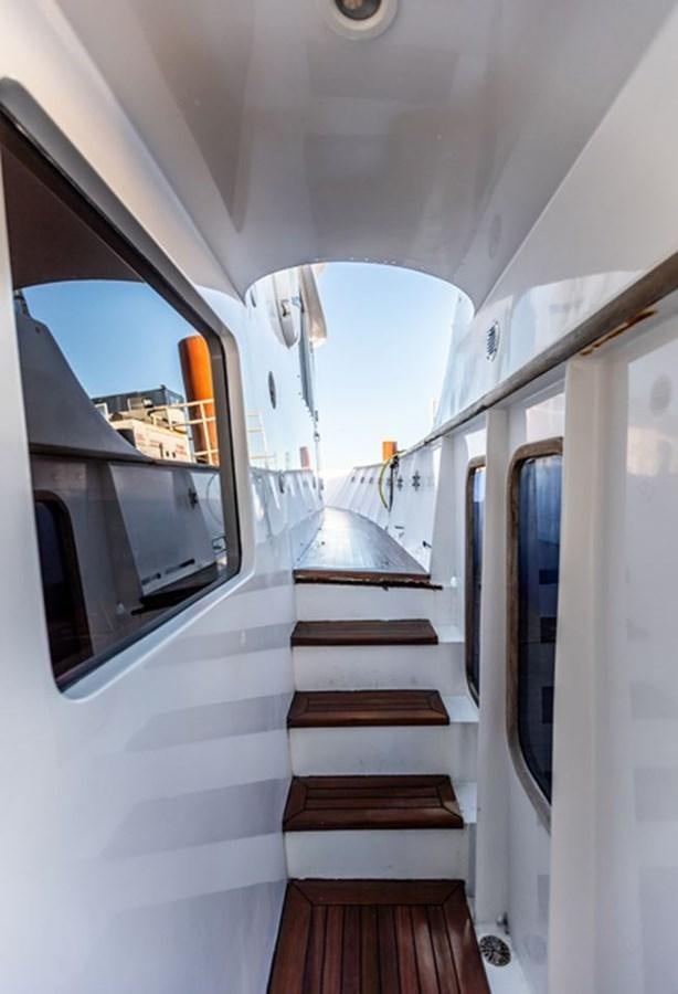 a white vehicle with a wooden staircase aboard HISTORY Yacht for Sale