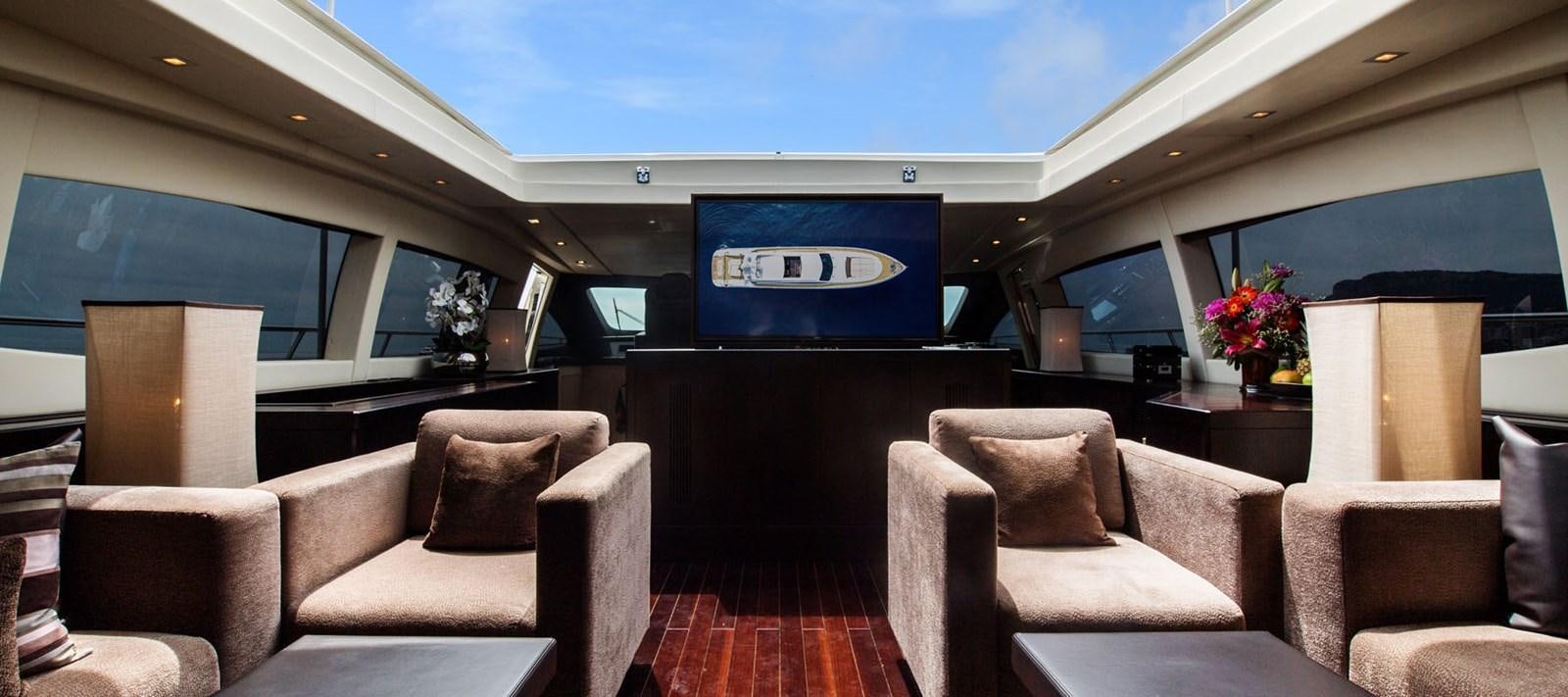 a room with couches and chairs aboard BLOOMS Yacht for Charter