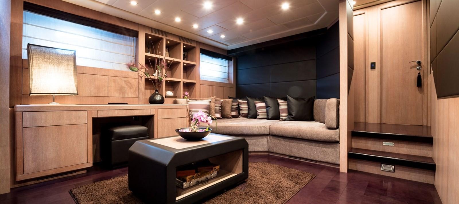 a living room with a couch and a table aboard BLOOMS Yacht for Charter