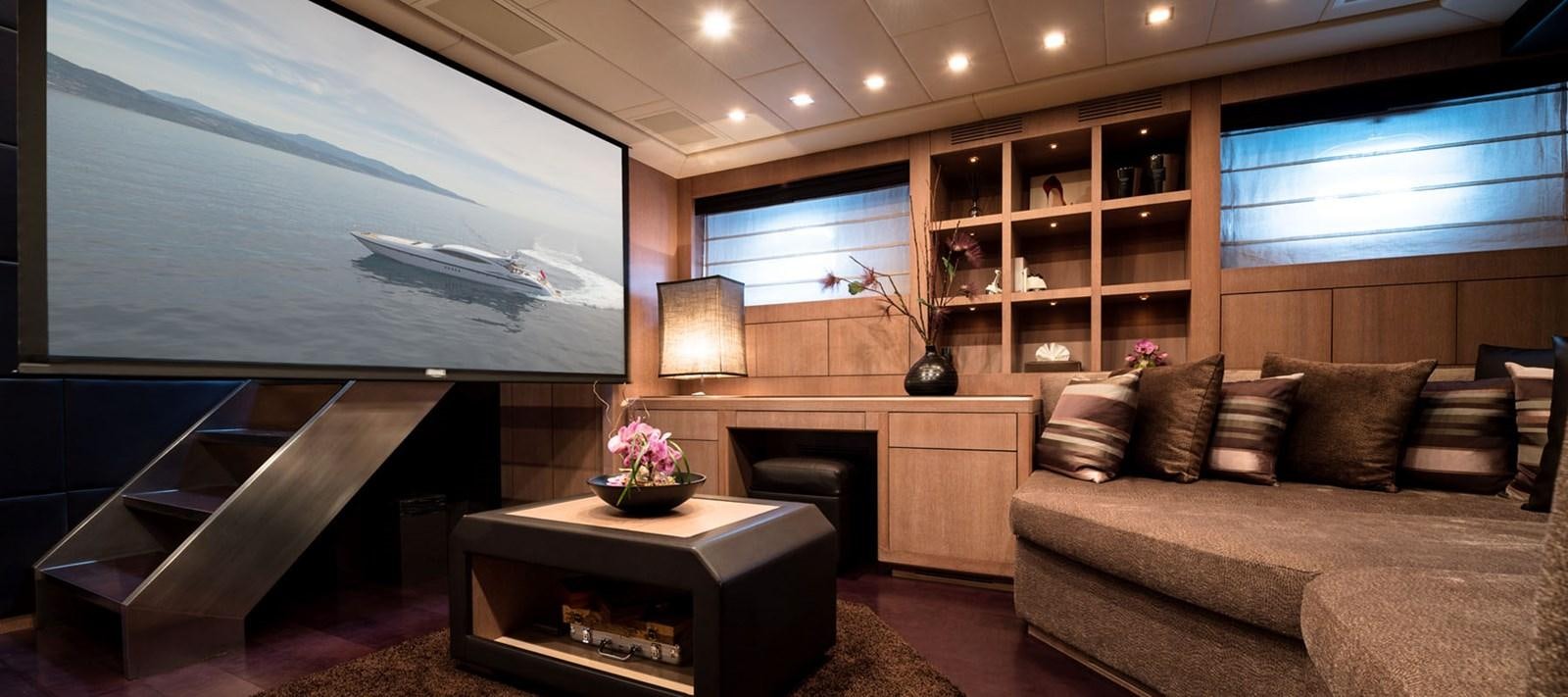 a living room with a couch and a coffee table aboard BLOOMS Yacht for Charter