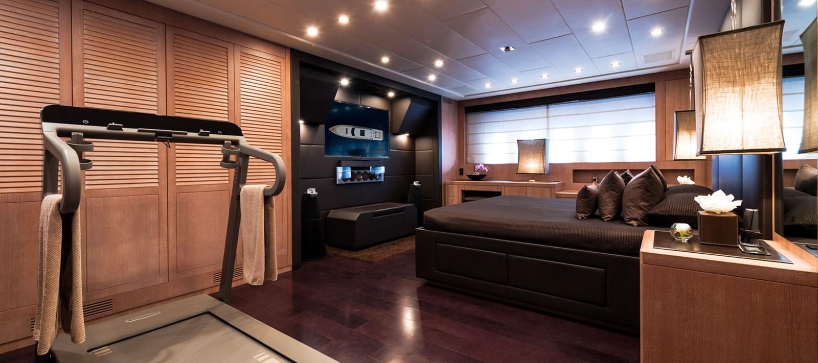 a living room with a couch and a tv aboard BLOOMS Yacht for Charter