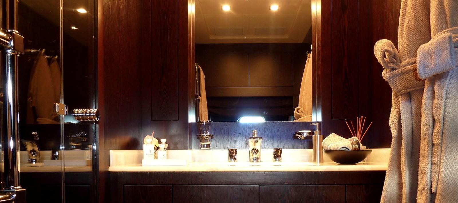 a bathroom with a sink and a large towel on the wall aboard BLOOMS Yacht for Charter